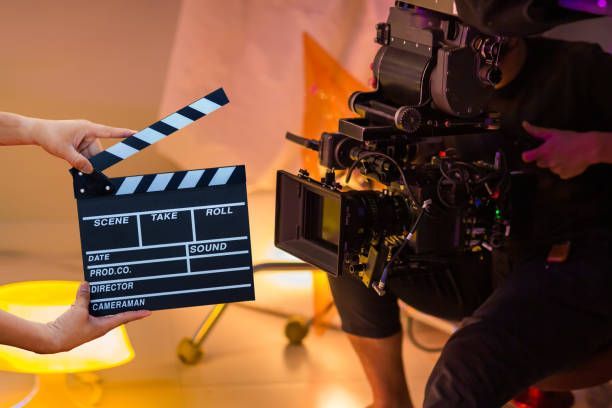 Man hands holding movie clapper. Film director concept. Behind the scenes of movie shooting or video production and film crew team
